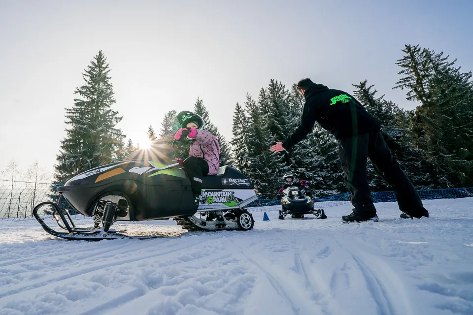 Kids snowmobiling in Les Gets